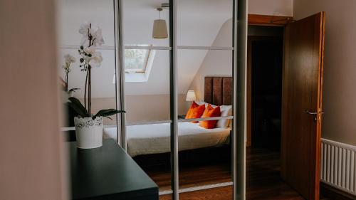 a bedroom with a bed with orange pillows at Five Lamps Suites in Dublin
