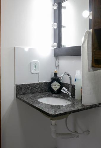a bathroom counter with a sink and a mirror at Pousada Rua de Lazer in Domingos Martins