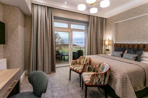 a bedroom with a bed and a large window at Lodore Falls Hotel & Spa in Keswick
