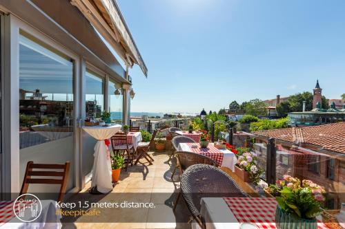 a balcony of a restaurant with tables and chairs at Best Point Suites Old City - Best Group Hotels in Istanbul