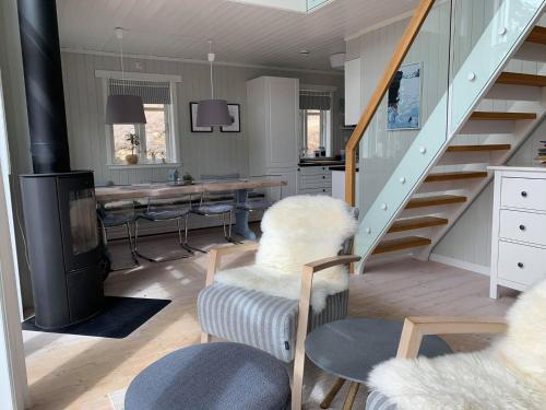 a living room with a staircase and a table at Lemonsjøen-Jotunheimen-Besseggen in Stuttgongfossen