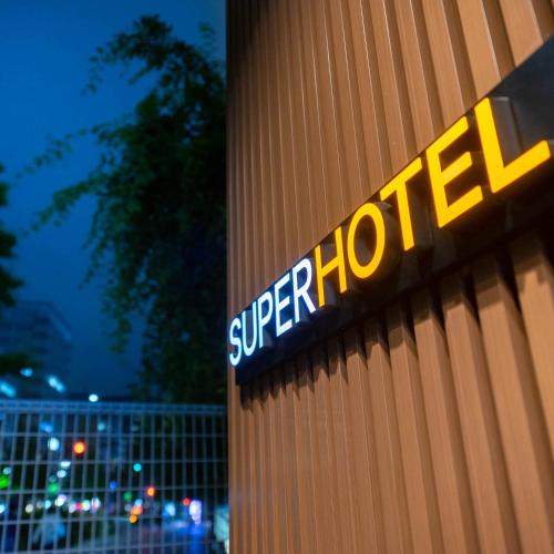 a sign on the side of a building at Super Hotel Sendai Hirose Dori in Sendai