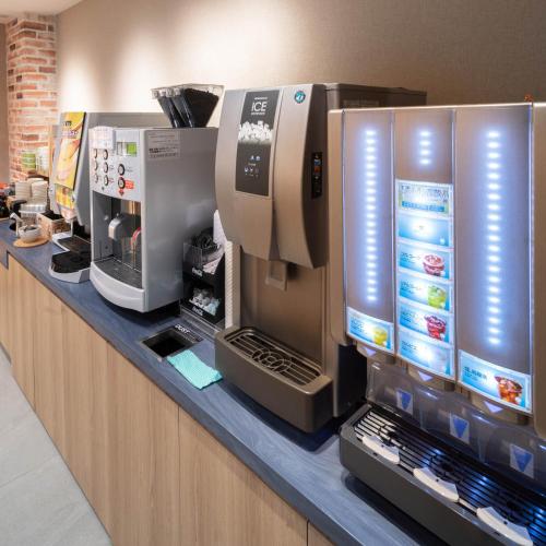 a counter with several coffee machines on it at Super Hotel Sendai Hirose Dori in Sendai