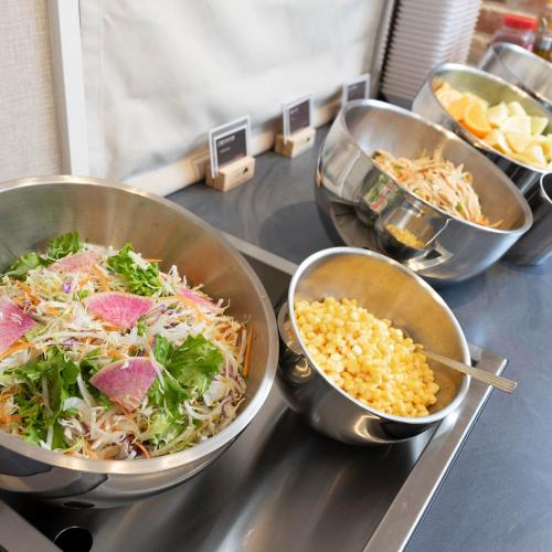 a counter with three bowls of food on a table at Super Hotel Sendai Hirose Dori in Sendai