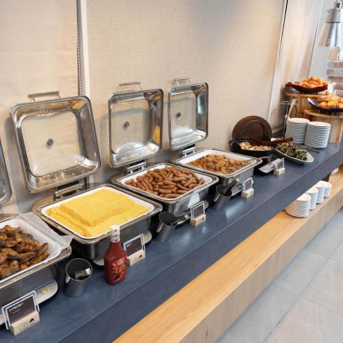 a buffet line with many different types of food at Super Hotel Sendai Hirose Dori in Sendai
