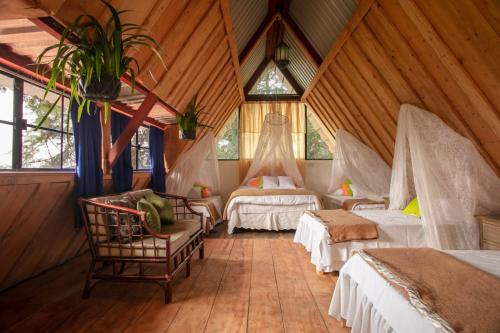 a bedroom with two beds in a room with wooden walls at Los Naranjos Town Houses in Los Naranjos