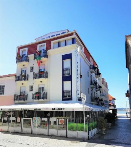 a large white building on the side of a street at Hotel Atlântica in São Martinho do Porto