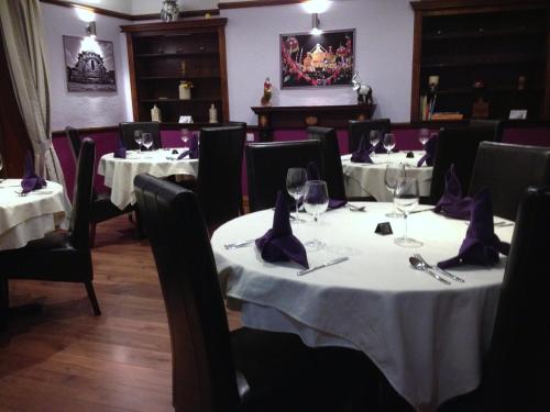 a dining room with tables and chairs with wine glasses at Croxdale Inn in Durham