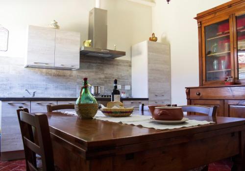 a kitchen with a wooden table with a bottle of wine at L'OZioRinco Apartments in Florence