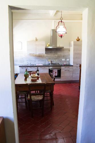 a kitchen with a wooden table in a room at L'OZioRinco Apartments in Florence