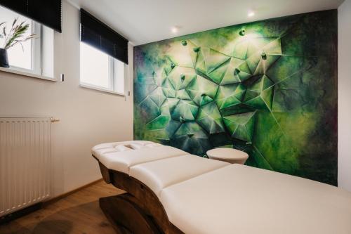 a room with a bed and a painting on the wall at Alpina Wagrain in Wagrain