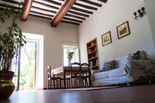 a living room with a table and a couch at L'OZioRinco Apartments in Florence