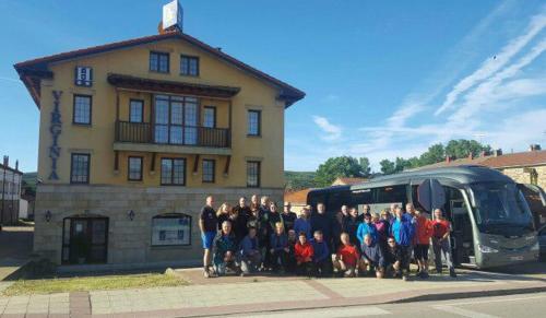 a group of people standing in front of a bus at Hotel Virginia R.H. in Vinuesa