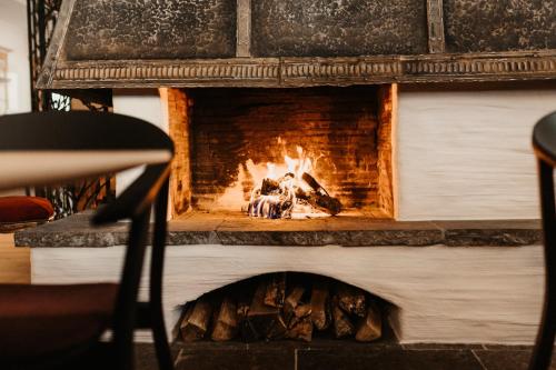 a fireplace with two people sitting in front of it at Alpina Wagrain in Wagrain