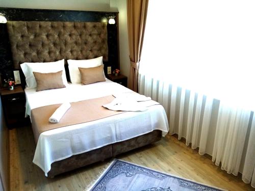 Ένα ή περισσότερα κρεβάτια σε δωμάτιο στο Yasin Apart hotel