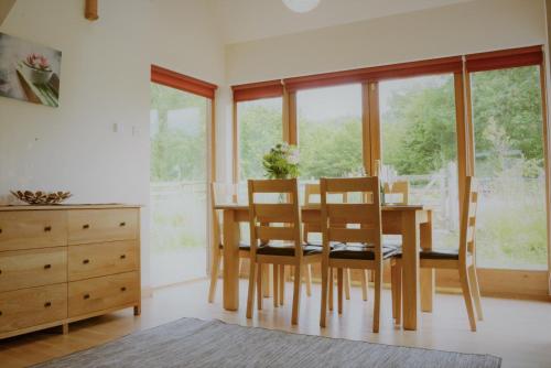 a dining room with a wooden table and chairs at Shepherds Rest in Fort William