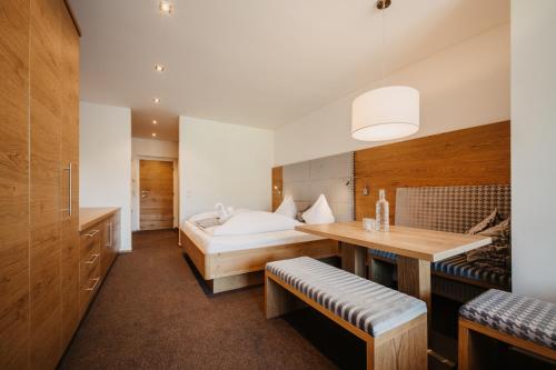 a bedroom with a bed and a desk in a room at Alpina Wagrain in Wagrain