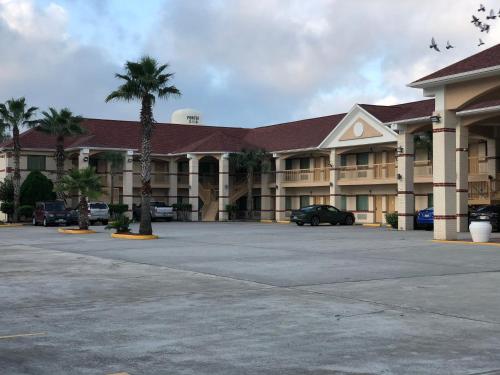 a large building with a car parked in a parking lot at Porter Executive Inn & Suites in Porter