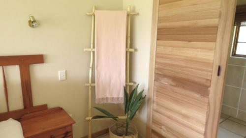 a bathroom with a wooden door with a towel at Old Inchgarth Farmstay in Himeville