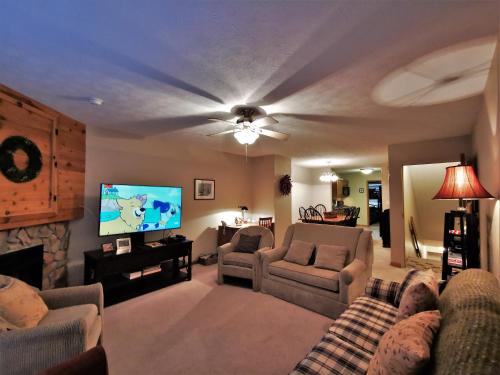 a living room with a couch and a tv at Gorgeous House for Ski Retreat or Mountain Vacations in Snowshoe
