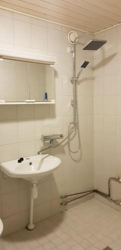 a bathroom with a sink and a shower at Studio near City - Puinnintie in Pori