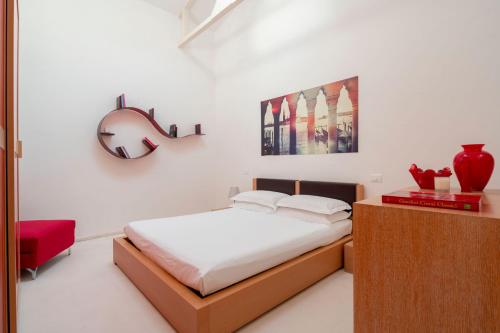 a bedroom with a bed and a red chair at The WaterView Alcove in Venice