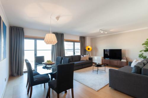 a living room with a couch and a table at Your Lisbon Home Parque das Nações in Lisbon