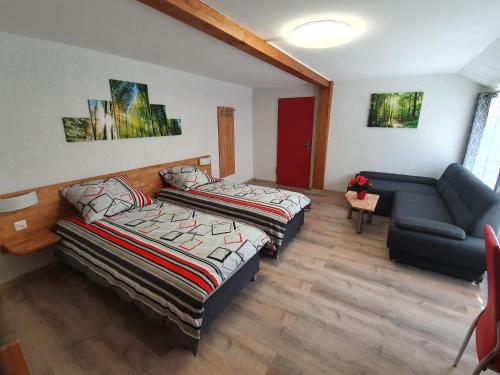 a living room with two beds and a couch at Gasthof Schwanen Radelfingen in Radelfingen