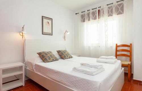 a bedroom with a white bed with towels on it at B14 - Heart of Old Town Apartment in Lagos