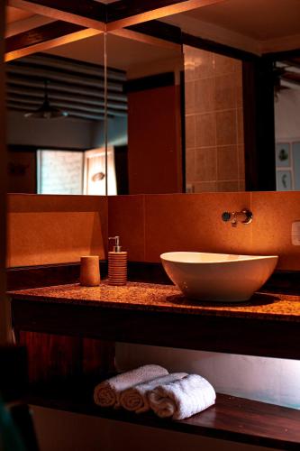 a bathroom with a sink and a large mirror at Cabañas del Cerro in Valle Grande