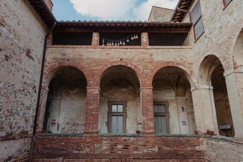 a brick building with arches on the side of it at Abbazia Sette Frati Agriturismo Fratres in Pietrafitta