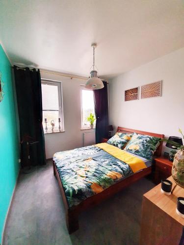 a bedroom with a bed and a table and a window at Meerblick - widok na morze in Puck