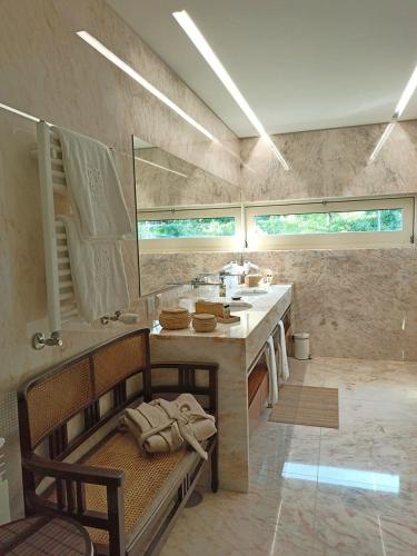 a large bathroom with a sink and a counter at Casa do Passal Country House in Paço de Sousa