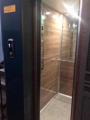 a glass door to a shower in a room at Freedom Square Apartment in Tbilisi City