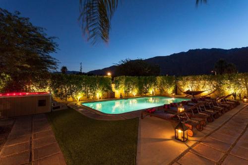 a swimming pool in a backyard at night with lights at Villa Cristine - Spanish Style Palm Springs Villa in Palm Springs