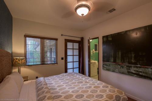 a bedroom with a bed and a large painting on the wall at Villa Cristine - Spanish Style Palm Springs Villa in Palm Springs