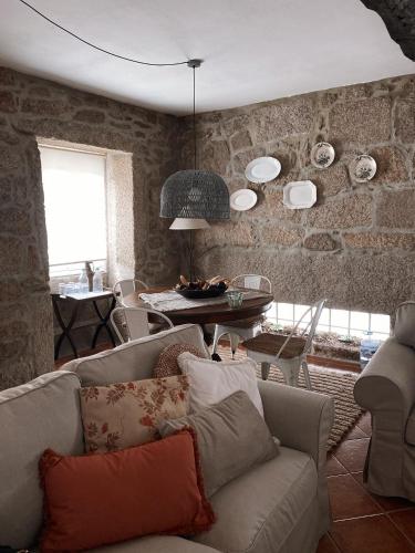 a living room with a couch and a table at Casa da Nogueira in Arcos