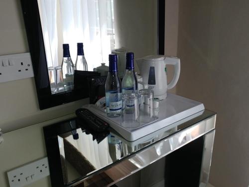 a counter with wine bottles and glasses on it at The Engine Inn in Holker