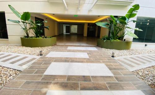 a hallway of an office building with plants at Departamento moderno pleno centro salta capital in Salta