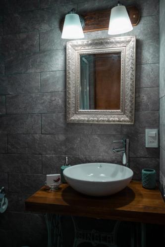 a bathroom with a white sink and a mirror at Aroma de la sierra in Villa Serrana