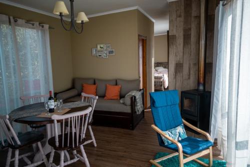 a living room with a couch and a table and chairs at aroma de la sierra in Villa Serrana