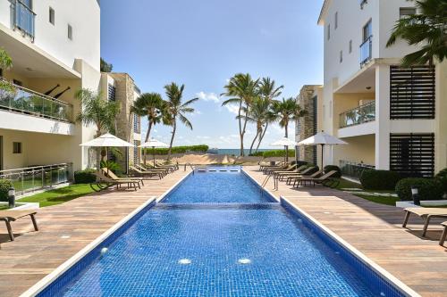 a large swimming pool in a residential area at Costa Atlantica Beach Condo in Punta Cana