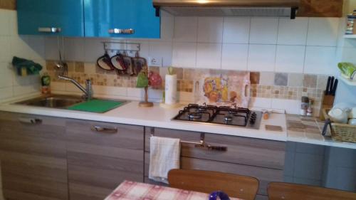 a kitchen with a sink and a stove in it at Casa Patti alle porte di Siena in Siena
