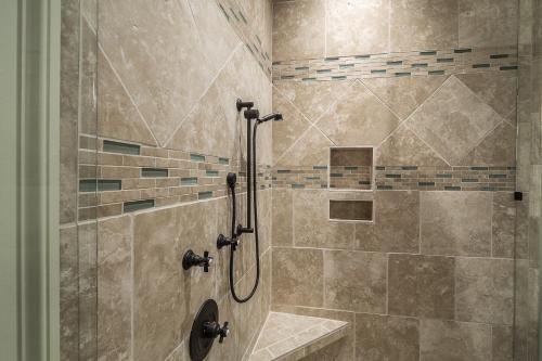 a shower stall in a bathroom with tiles at Deer Run Lodging House in Skaneateles