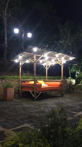 a bed under a wooden gazebo at night at Hotel Casas de Campo El Ciruelo in San Gil