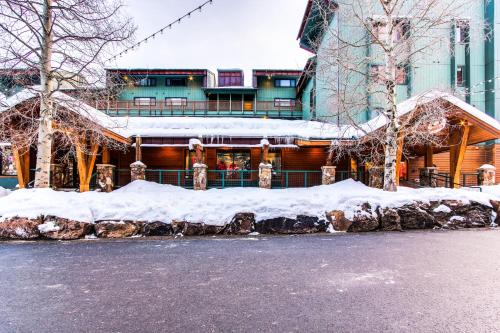 a building covered in snow in front of a street at Anaconda 102 in Copper Mountain