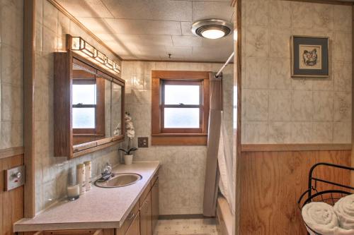 a bathroom with a sink and a mirror at Diamond Lake Home with Dock Close to 2 Ski Resorts! 