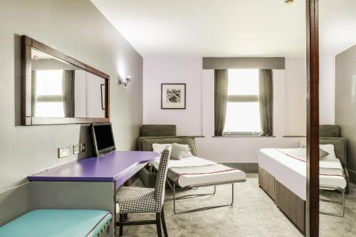a room with a purple desk and a bed at Best Western Sheffield City Hotel in Sheffield