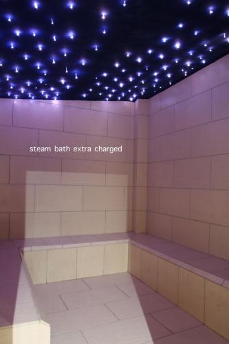 a room with a bench with lights on the ceiling at Boutique Hotel Skamnos Arachova in Arachova