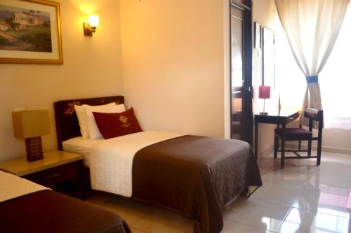 Cama o camas de una habitación en Hotel Aztlan